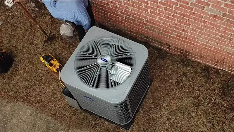 Technician installing an outdoor AC unit for a home replacement