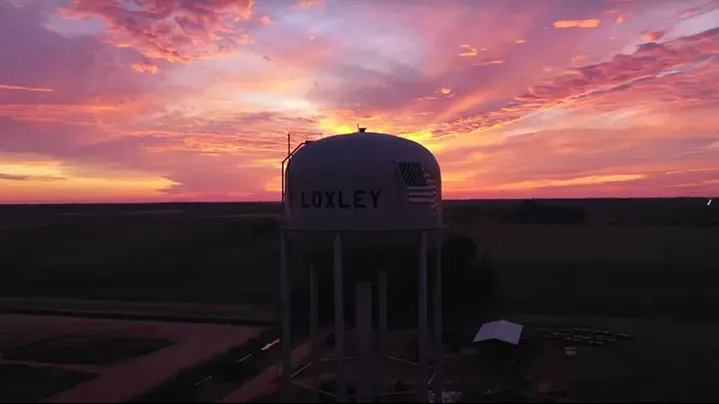 The Loxley water tower at sunset, seen from the air, with LOXLEY painted across the tank