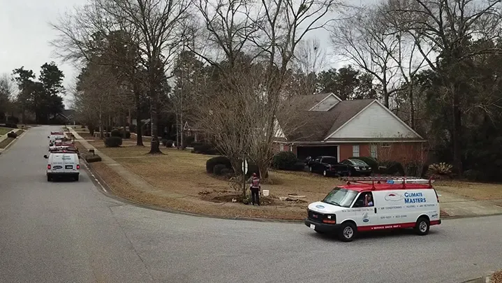 Climate Masters, Inc. service vans parked in a residential Spanish Fort neighborhood for prompt AC repair