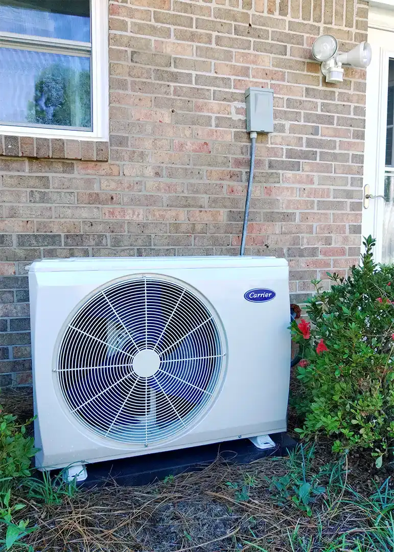 Carrier ductless mini split outdoor unit installed against brick in Spanish Fort