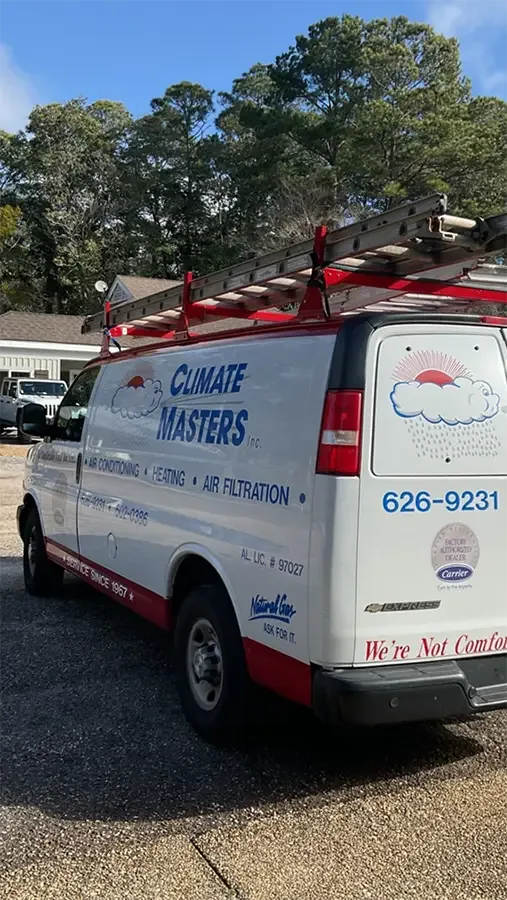 A Climate Masters service van with a ladder rack parked outside a home in Fairhope