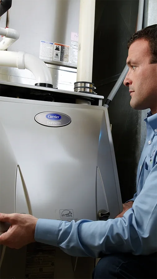 Technician installing a customer heating replacement system