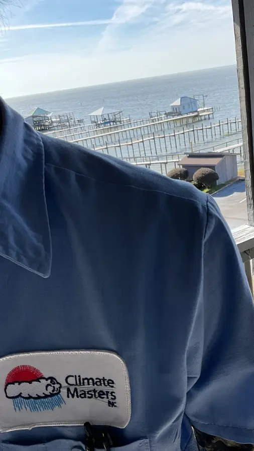 HVAC technician Daniel at Fairhope home with Mobile Bay in the background | Climate Masters INC