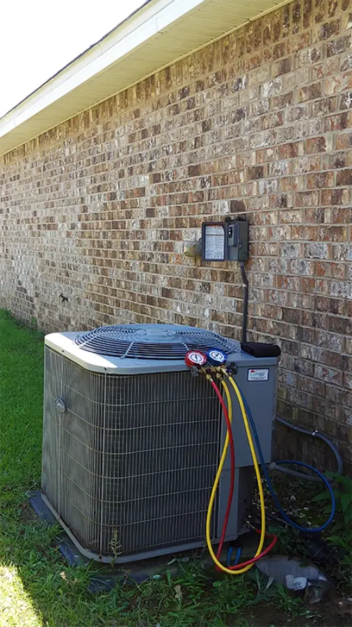 HVAC gauge manifold hooked up to a outdoor unit | AC Maintenance | Climate Masters Inc.