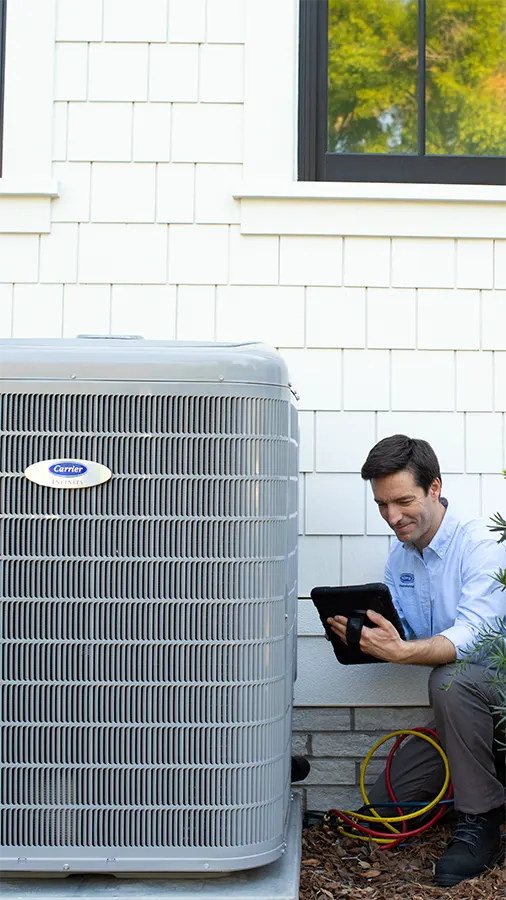 HVAC technician preforming maintenance on a outdoor unit | AC Maintenance | Climate Masters Inc.
