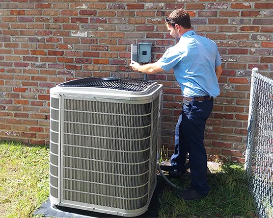 Climate Masters Inc. technician checking outdoor air conditioner | Air Conditioner Repair | Climate Masters Inc.