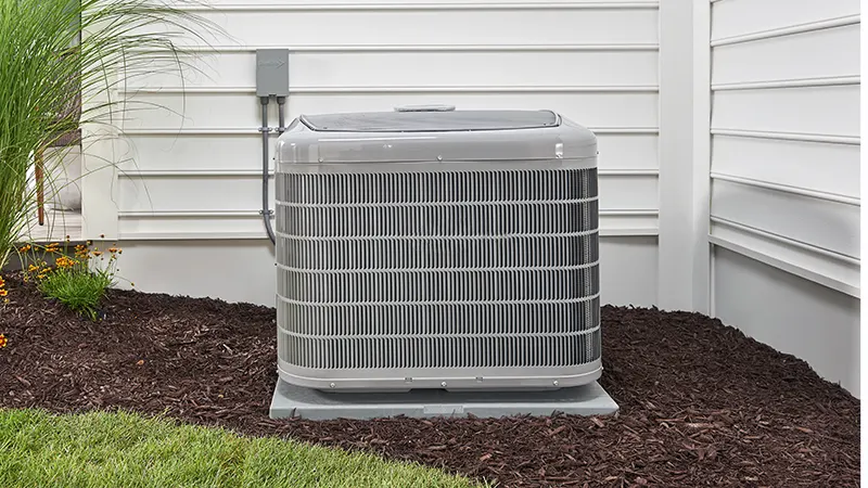 Front view of a heat pump outdoors | Heat Pump Repair | Climate Masters Inc.
