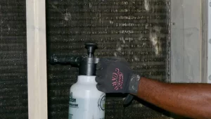 Man cleaning condenser coil | Climate Masters INC | AC repair | AC Unit Repair