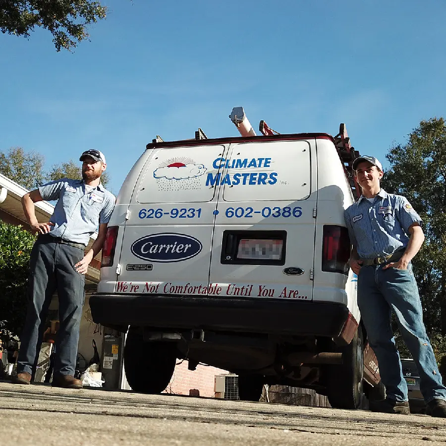 Climate Masters INC | Air Conditioning Contractor | Two HVAC technicians by Climate Masters work truck