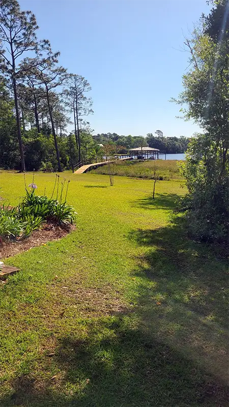 Gazebo with walkway beside a lake in backyard in Mobile, Alabama | Climate Masters Inc.