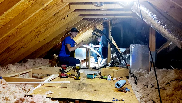 Climate Masters duct repair technician in homeowner's attic | Climate Masters INC