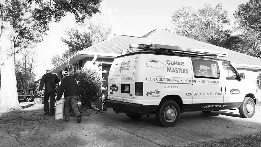 Two Climate Masters technicians walking toward home from van | Spanish Fort, AL | Climate Masters Inc