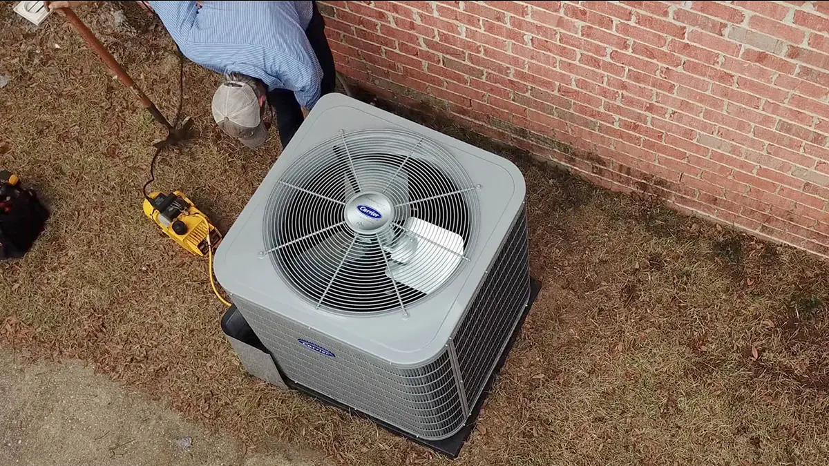 Climate Masters HVAC technician installing carrier unit.